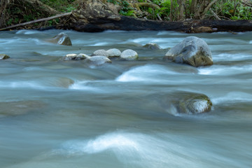 The water flow through the rocks in a stream at Wang Nan Pua , Nan in Thailand.