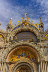 Fototapeta na wymiar The Patriarchal Cathedral Basilica of Saint Mark at the Piazza San Marco - St Mark's Square, Venice Italy. The exterior of the west facade of Saint Mark's Basilica (Basilica di San Marco).