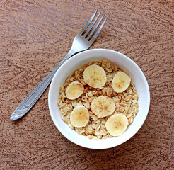 Oat flakes in a white bowl and fork