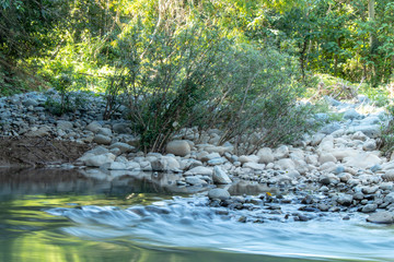 Naklejka na ściany i meble The water flow through the rocks in a stream at Wang Nan Pua , Nan in Thailand.