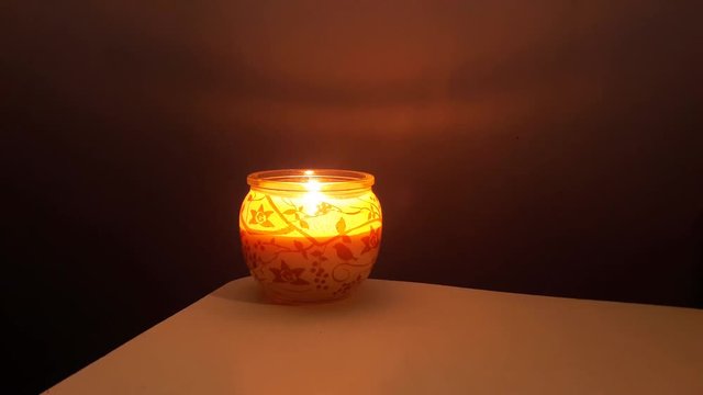 Close up shot of a Christmas candle burning.. Christmas time. Making a cosy  home. Cinamon smell candle.