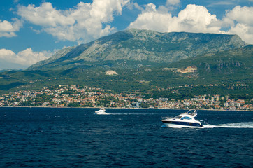 Moving white yachts on Boka Kotor bay near Herceg Novi, Montenegro