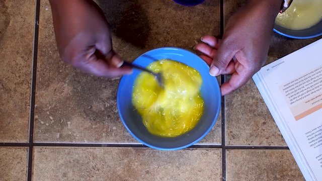 Woman Beating And Stirring Eggs With Fork, Overhead Close Up