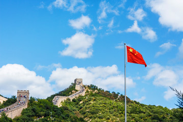 The Great Wall of China. Chinese flag against the background of the blue sky and of the Great Wall