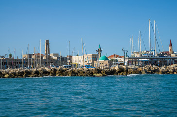 Fototapeta na wymiar Port of Acre, Sinan Pasha Mosque and the clock tower of Khan el-Umdan