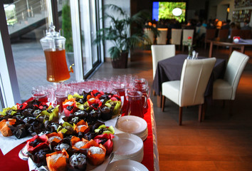 catering table with sweets and juice.