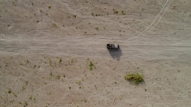 Aerial view above road in valley with a off road jeep in Tarlac, Philippines.