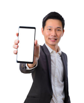 Young asian business man show blank screen smartphone in black suit