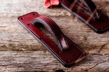 Handmade exclusive red leather door handles in the shape of the handle of a vintage suitcase on old...