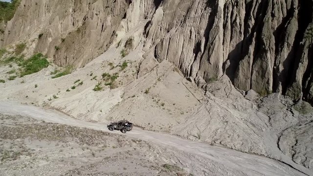 Aerial view of road in valley with a off road jeep in Tarlac, Philippines.