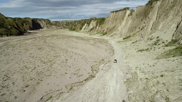 Aerial view of road in valley with a off road jeep in Tarlac, Philippines.