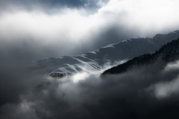 Clouds and light effects on the snow in the mountains