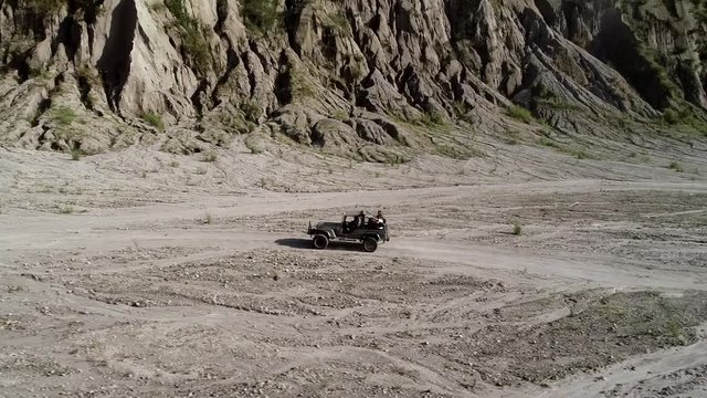 Aerial view of road in valley with a off road jeep in Tarlac, Philippines.