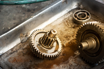 Old shiny motorcycle gears. Disassembly of the engine