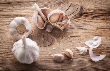 Garlic bulbs and cloves on wooden table, closeup