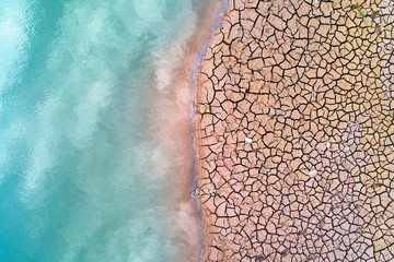 Top view of the cracked earth and water surface.