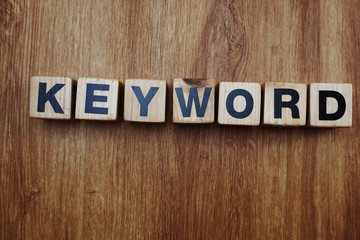 Fototapeta premium keyword word created with cubes alphabet letters on blue background