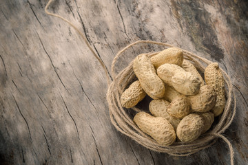fresh peanuts on a wooden rustic background