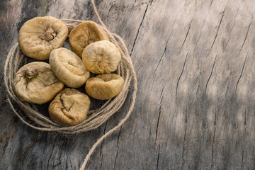 Dried figs in twine on grey wooden table