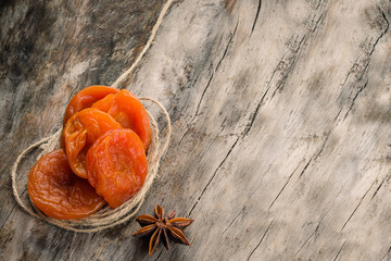 dried apricots on a dark wood background. tinting. selective focus