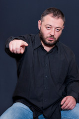 Portrait of man pointing on camera with finger