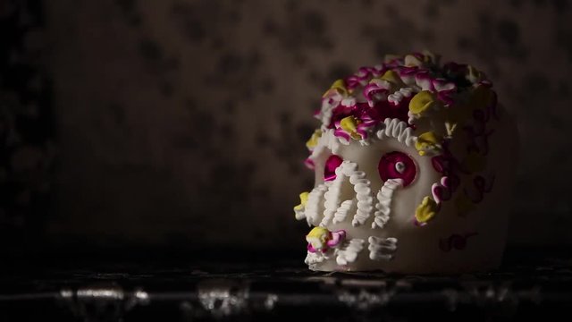 A Calavera is a representation of a human skull and made from either sugar and are decorated with colored foil and icing which is used in the Mexican celebration of the Day of the Dead. 