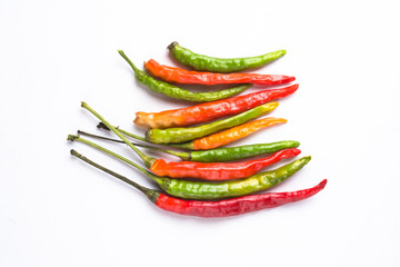 Close-up of colorful hot peppers. Group of red green and yellow peppers on white background