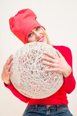 Blonde woman holding white wicker ball