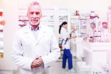 Naklejka na ściany i meble Professional wise pharmacists working in a drugstore