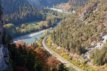 Fototapeta na wymiar Train in sunny autumnal Ruinaulta - Rheinschlucht (Rhine canyon), Illanz/Glion - Reichenau, Switzerland