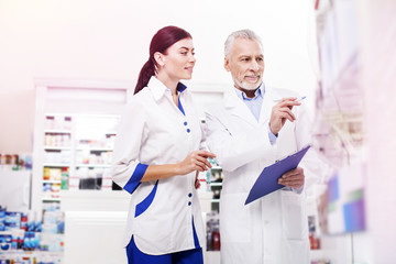 Pharmacists making a revision in a drugstore.