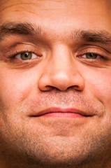 Smug, positive, smiling man. Facial expression, emoji face, emotion close-up.