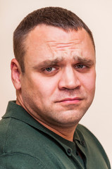 Fototapeta premium Side portrait of sad man on white background