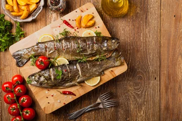 Zelfklevend Fotobehang Grilled whole trout. Served with baked potatoes. © gkrphoto