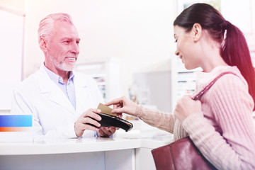 Customer swiping her credit card buying prescribed pills