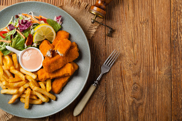 Fish sticks with fries and salad.