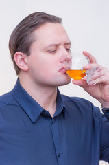 Fototapeta premium Man drinking whiskey or brandy alcohol drink
