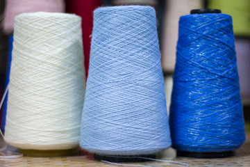 three reels of blue shades of yarn