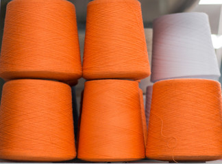 orange yarn in coils on shelf