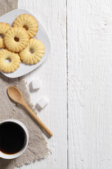 Sweet cookies and coffee on table