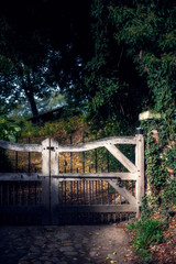 Fototapeta na wymiar Wooden gate in countryside in sunlight.