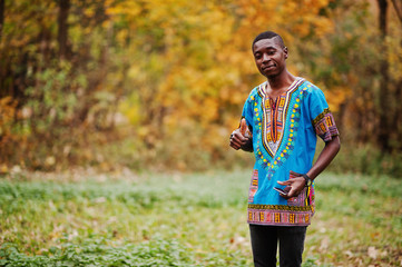 Fototapeta premium African man in africa traditional shirt on autumn park.