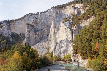 View of cliffs from sunny autumnal Ruinaulta - Rheinschlucht (Rhine canyon) near Versam-Safien, Switzerland