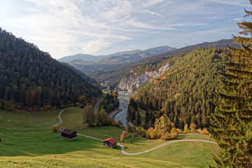 View of cliffs and Isla pastures in sunny autumnal Ruinaulta - Rheinschlucht (Rhine canyon) near Isla, Valendas-Carrera, Switzerland