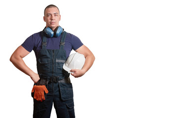 Strong male mechanic in blue overal standing on a white isolated background