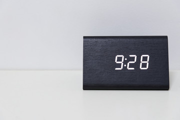 Black digital clock on a white background showing time 9:28