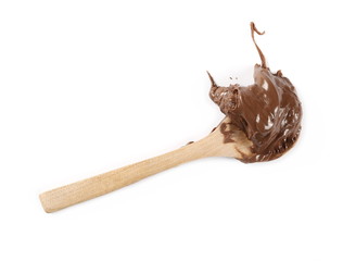 Chocolate cream in wooden spoon isolated on white background, top view