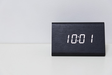 Black digital clock on a white background showing time 10:01