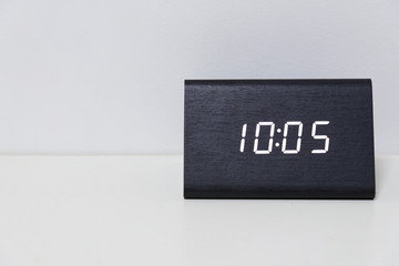 Black digital clock on a white background showing time 10:05