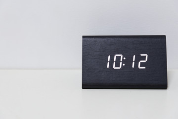 Black digital clock on a white background showing time 10:12